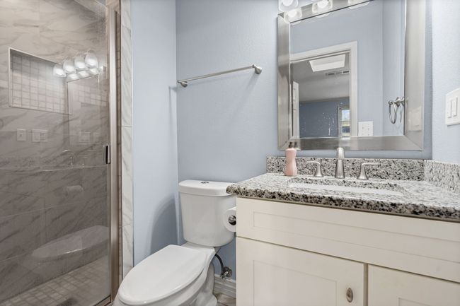 Bathroom with vanity and a shower stall | Image 20