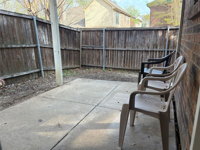 View of patio with a fenced backyard | Image 19