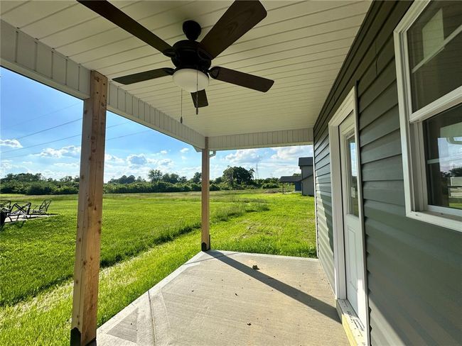 View of patio with a ceiling fan and a view of countryside | Image 4