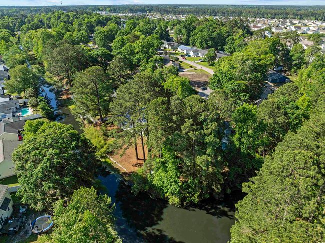 Drone / aerial view with a wooded view, a water view, and a residential view | Image 34