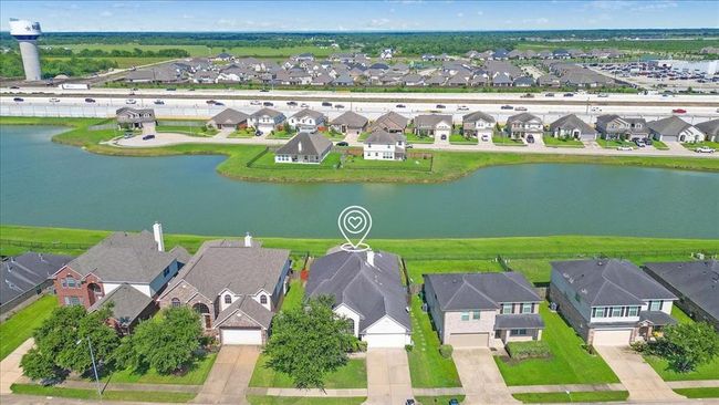 Property facing a scenic waterway. The house offers a serene view and convenient access to nearby roads and amenities. | Image 30