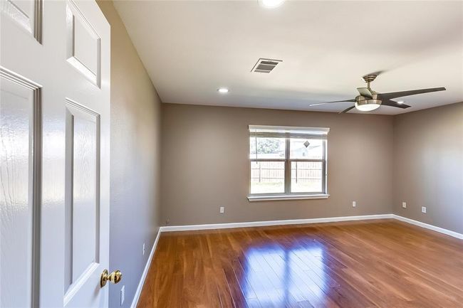 Unfurnished room featuring wood finished floors, ceiling fan, and recessed lighting | Image 15