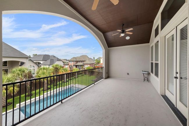 Enjoy elevated views and fresh air from the covered upstairs balcony—perfect for morning coffee, evening cocktails, or simply soaking in the beauty of your private backyard oasis. | Image 31