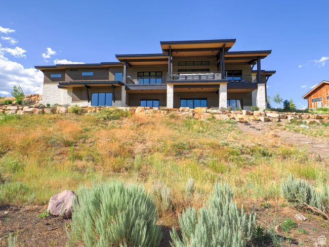 Back of property with a balcony and stone siding | Image 7
