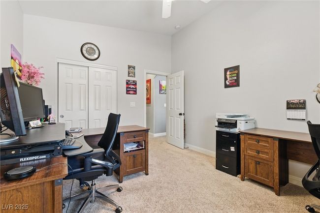 Home office featuring lofted ceiling, light carpet, baseboards, and ceiling fan | Image 24