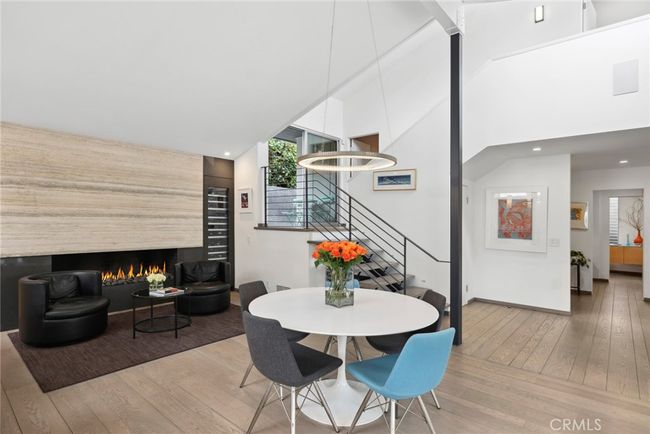 Three ensuite bedrooms and three- and one-half baths, each with its unique high-end style, are joined by a great room with dramatic floating fireplace that opens to an exquisite chef’s kitchen. | Image 14