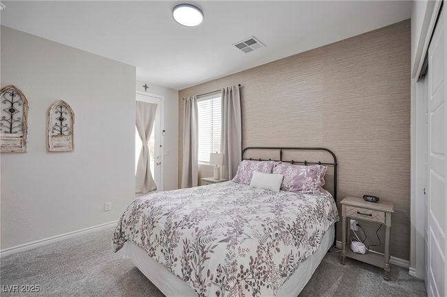 Carpeted bedroom featuring baseboards and visible vents | Image 11