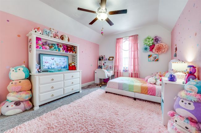 Carpeted bedroom with ceiling fan and lofted ceiling | Image 20