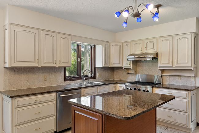 Granite counters and tile floors. | Image 10