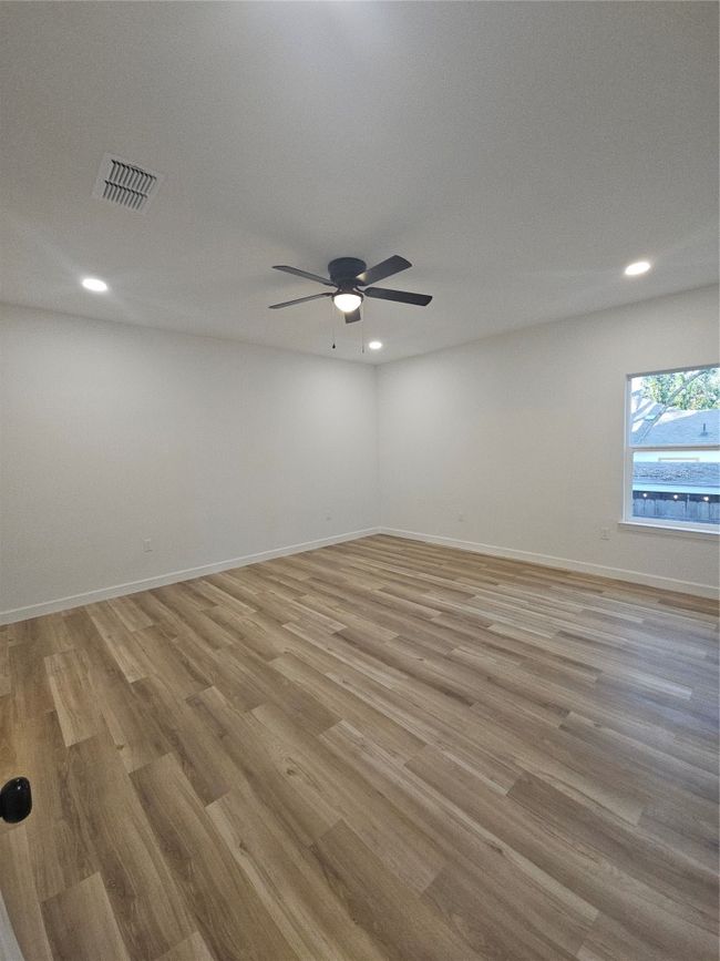 Unfurnished room featuring visible vents, baseboards, a ceiling fan, and light wood finished floors | Image 8