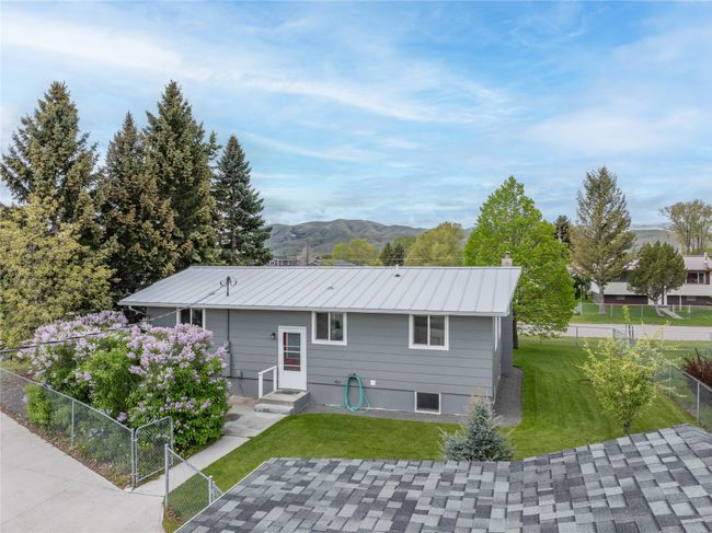 Back of house with a mountain view, a chimney, a patio area, and metal roof | Image 5