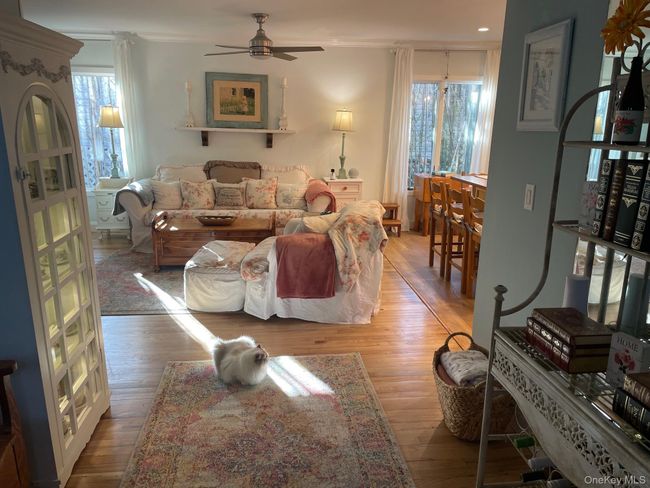 Living area with wood finished floors, ceiling fan, and recessed lighting | Image 6