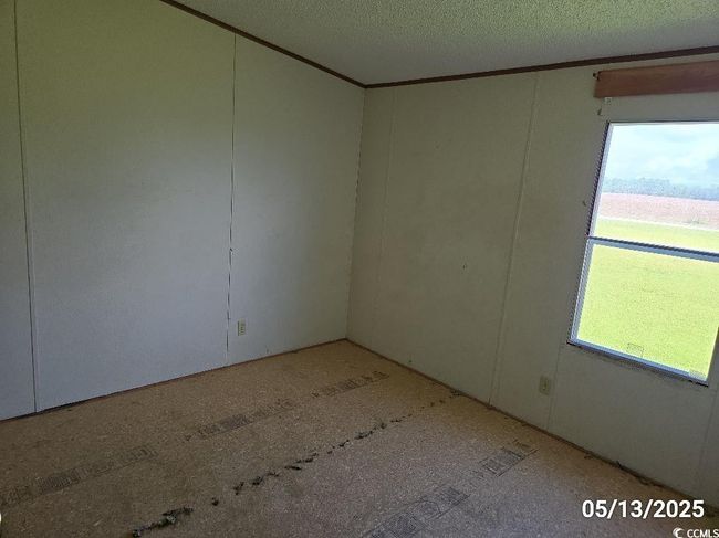Unfurnished room with a textured ceiling and ornamental molding | Image 31