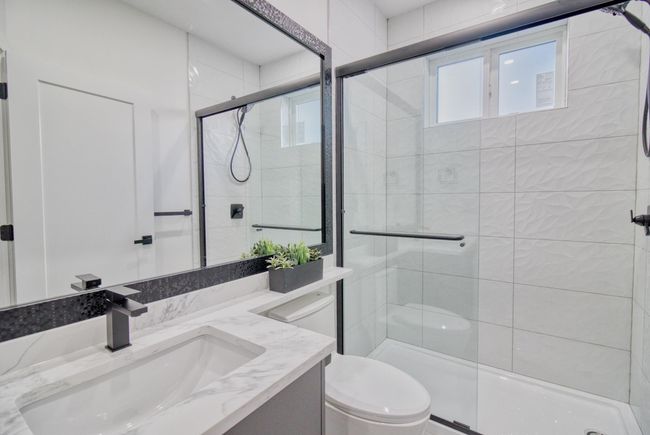 Full bath featuring vanity, a shower stall, and toilet | Image 18