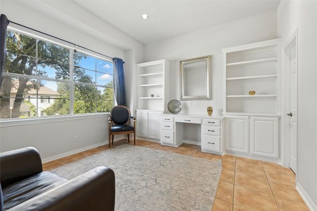 Home office with built in study area and light tile patterned flooring | Image 19