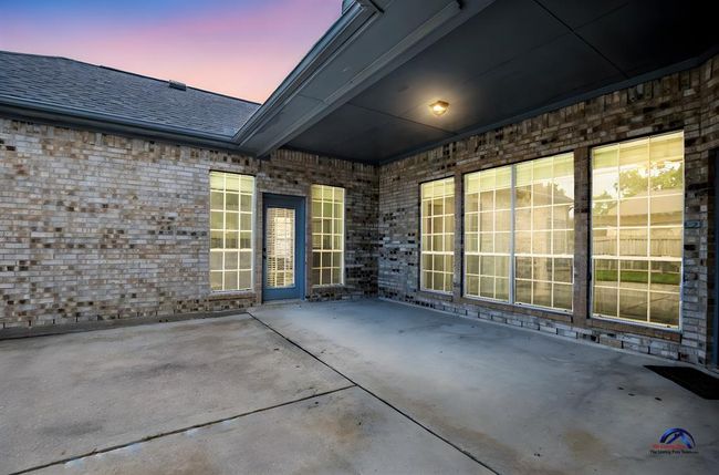 A spacious, covered back patio ideal for outdoor relaxation and entertaining. | Image 42