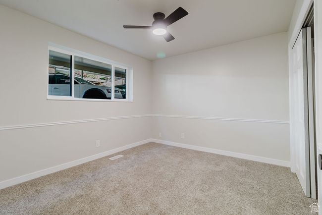 Spare room featuring ceiling fan, carpet floors, baseboards, and visible vents | Image 10