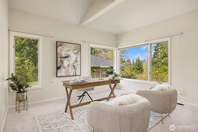 This den features lovely picture windows, a wood burning fireplace and vaulted ceilings. | Image 24