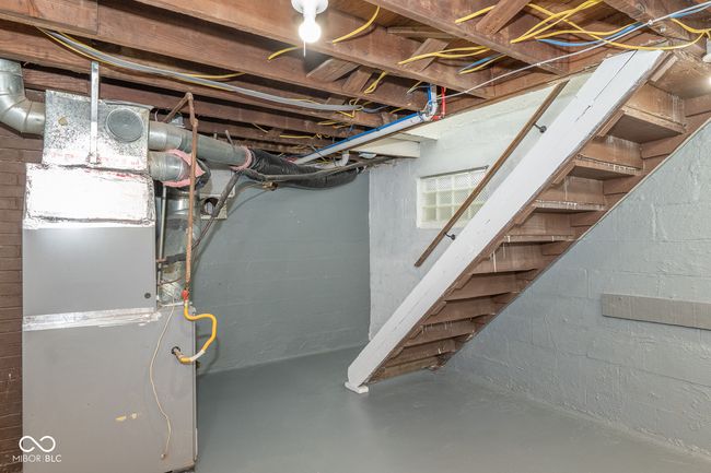 unfinished below grade area with concrete block wall and stairway | Image 27