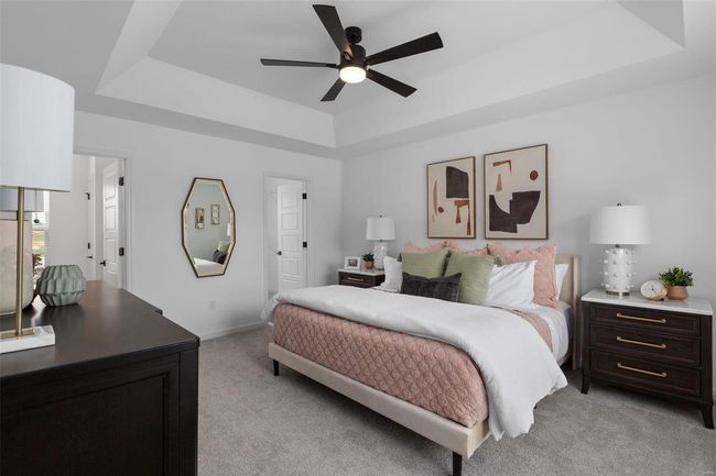 Carpeted bedroom featuring a tray ceiling and ceiling fan | Image 16
