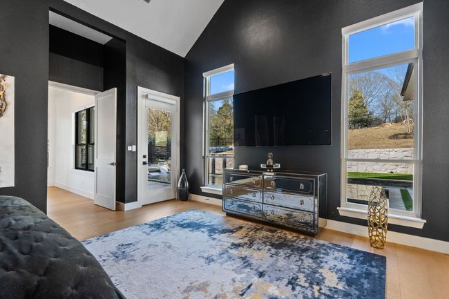 Living area featuring high vaulted ceiling, baseboards, and wood finished floors | Image 15