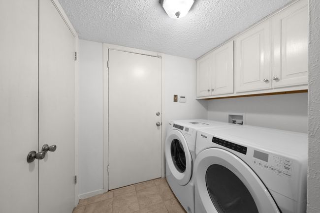 Downstairs oversized laundry room with storage cabinets and storage closet opens to garage and to kitchen. Washer-dryer are negotiable. | Image 20
