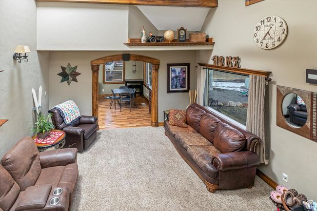 Living room featuring lofted ceiling and carpet flooring | Image 9