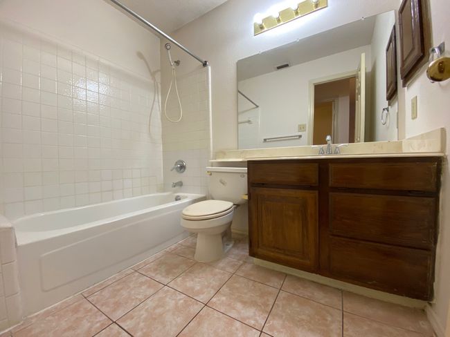Bathroom featuring shower / bathtub combination, vanity, and tile patterned floors | Image 14