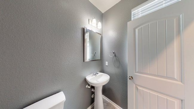 Bathroom featuring a textured wall and toilet | Image 6
