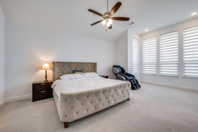 Bedroom with light carpet, baseboards, lofted ceiling, a ceiling fan, and recessed lighting | Image 21