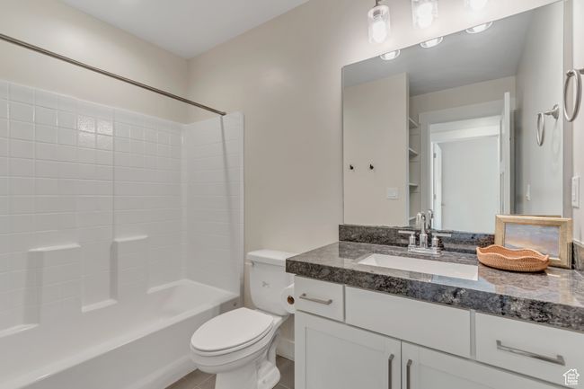 Bathroom with vanity, bathing tub / shower combination, and tile patterned floors | Image 22