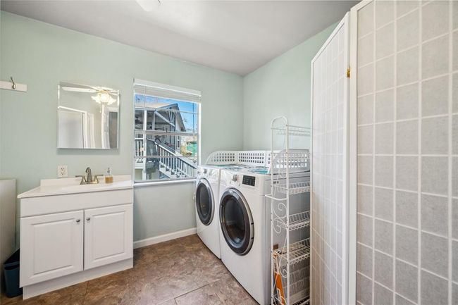 Bathroom with shower and laundry facility. | Image 20