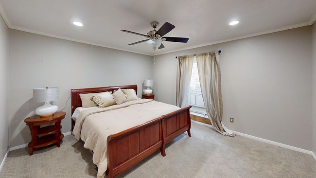 Bedroom with light carpet, baseboards, and crown molding | Image 17