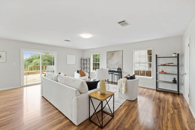 Living area featuring healthy amount of natural light, wood finished floors, and baseboards | Image 10