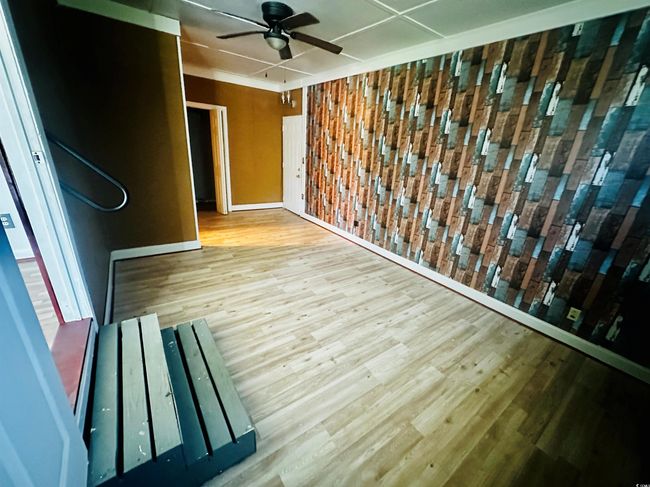 Unfurnished room featuring wood finished floors, a ceiling fan, and baseboards | Image 6