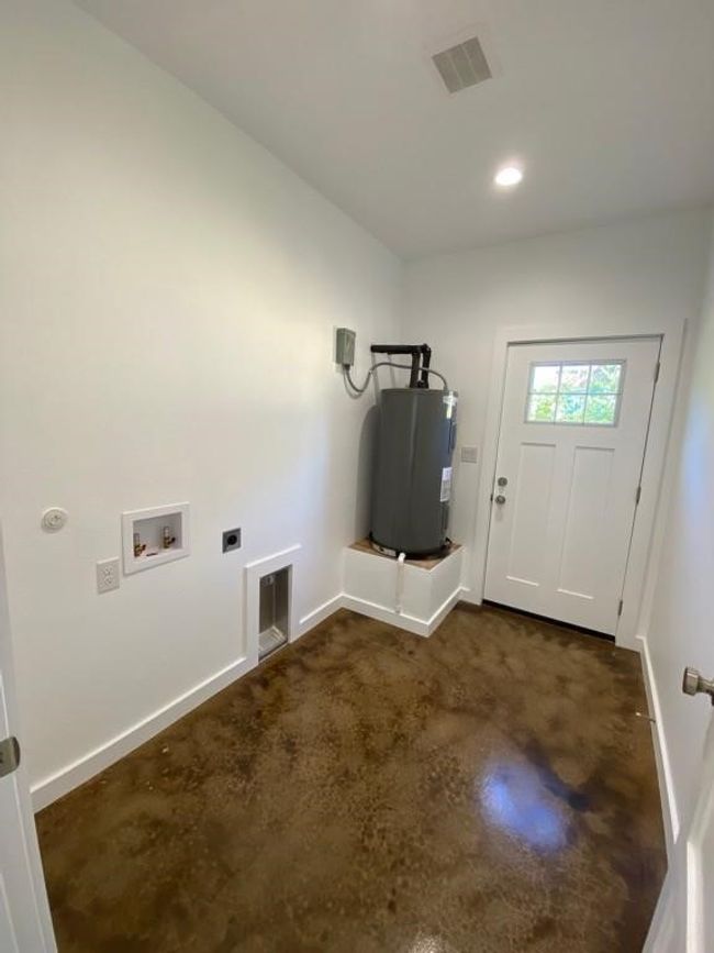 Laundry area with water heater, hookup for a washing machine, electric dryer hookup, baseboards, and recessed lighting | Image 21