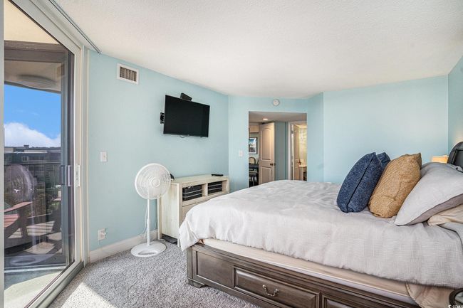 Bedroom featuring light carpet, access to outside, and a textured ceiling | Image 15