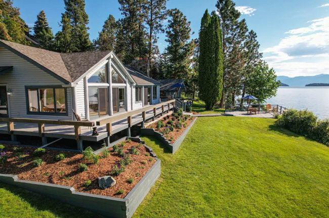 View of yard with a deck with water view and a patio area | Image 6