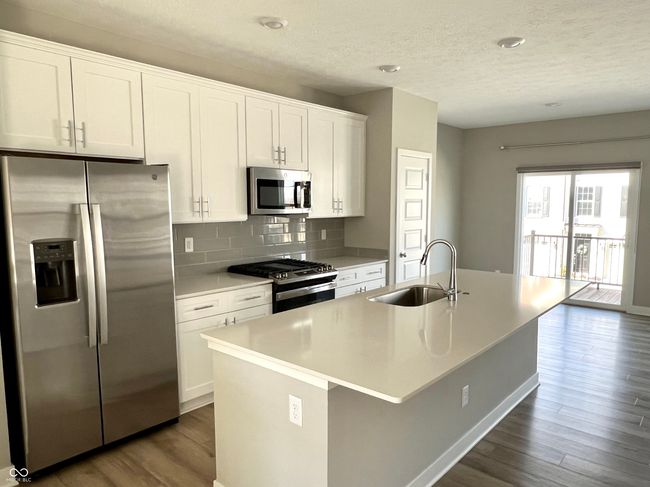 Gourmet chef's kitchen with SS appliances, gas range, Shelf Genie cabinet system, quartz countertops. Open to hearth room. | Image 14