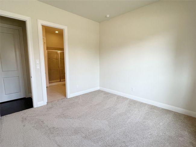 Unfurnished bedroom with light colored carpet and connected bathroom | Image 14