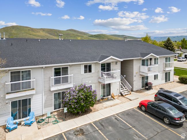 View of building exterior with uncovered parking and a mountain view | Image 27