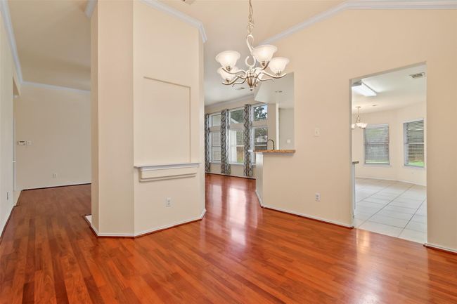 View from the dining room looking into the family room and kitchen showcasing the open concept feel of the home. | Image 6