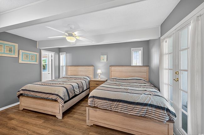 Bedroom with wood finished floors, multiple windows, and a ceiling fan | Image 22