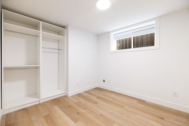 Unfurnished bedroom with light wood-type flooring and a closet | Image 39