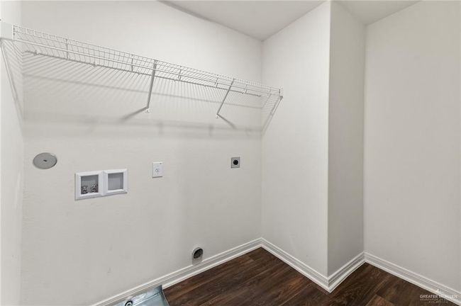 Laundry area with hookup for an electric dryer, washer hookup, dark wood-style floors, and baseboards | Image 24