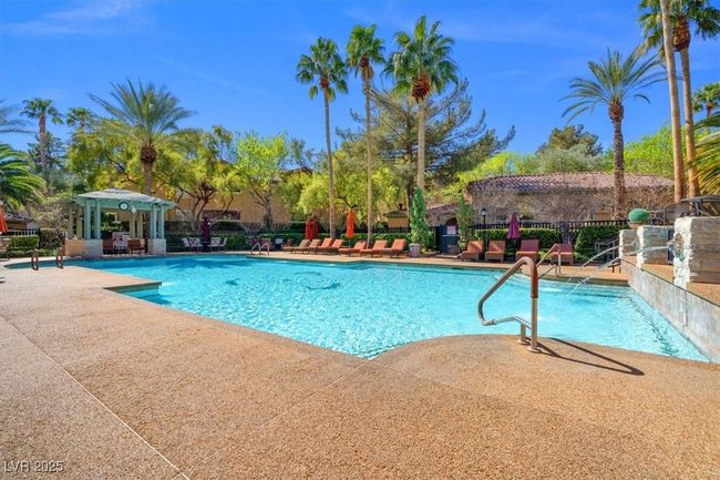 Pool with a patio area and fence | Image 20