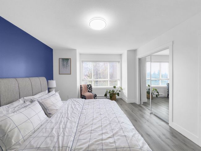 Bedroom with wood finished floors, baseboards, and a closet | Image 22