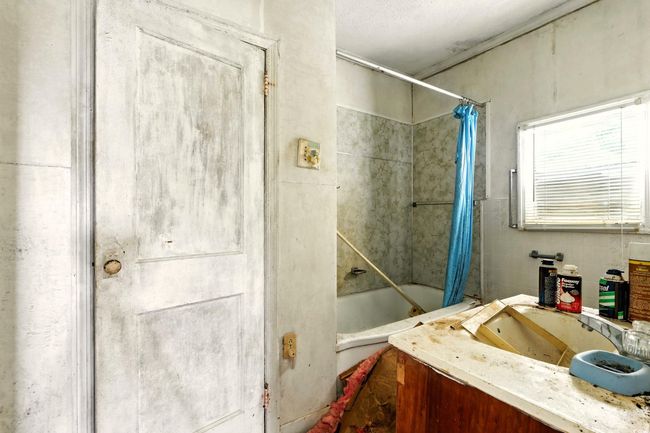 Full bathroom featuring shower / bath combo and vanity | Image 6