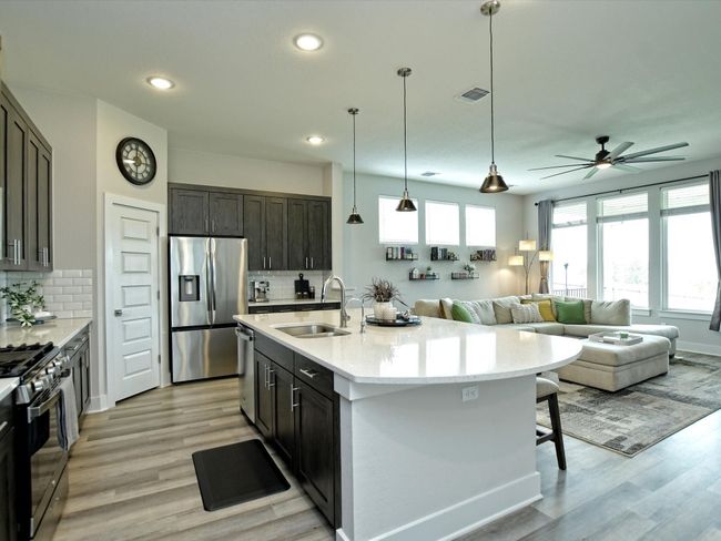 Love how the Quartz counters overhand the cabinets to create even more seating | Image 10