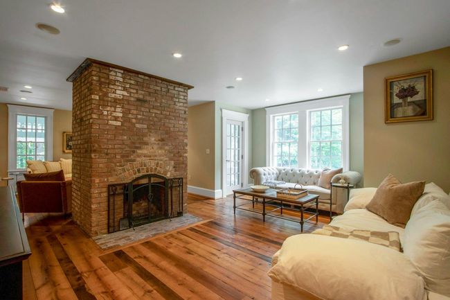 Living area with hardwood / wood-style floors, a brick fireplace, recessed lighting, and baseboards | Image 6